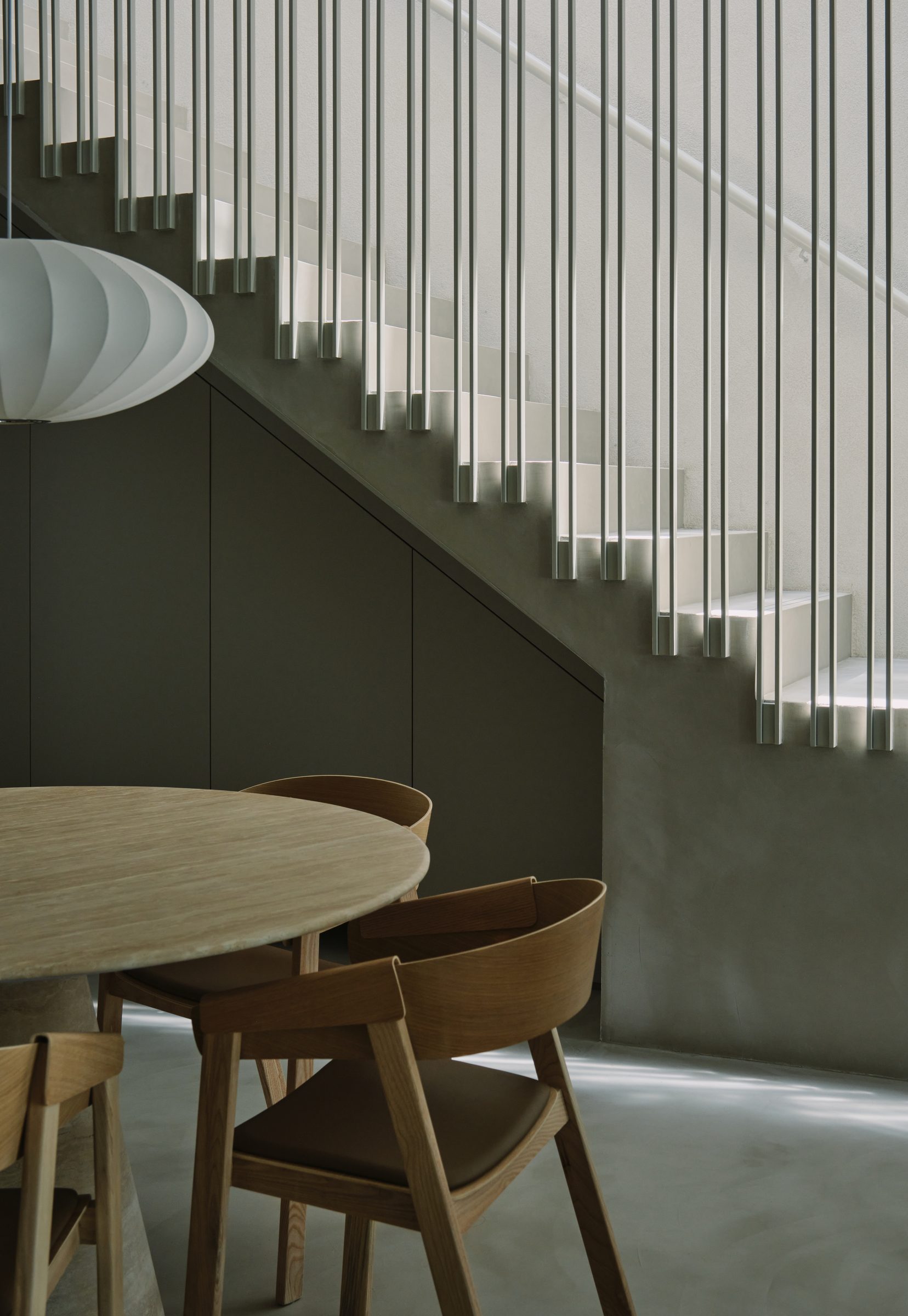 The dining room and stair, suspended rod balustrade catching light